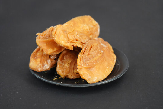 Delicious khaja of puri in black plate and background