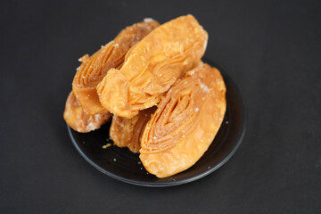 Crunchy khaja in black plate