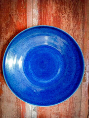 vintage ceramic blueish platter on a wooden background