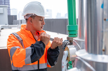 The image captures a skilled engineer inspecting a network of pipelines in a petrochemical facility. the concept of projects related to petrochemicals, engineering, and industrial inspection.