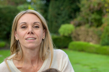 Woman Smiling in a Garden Setting