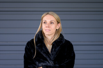 Woman in Black Fur Coat with Thoughtful Expression
