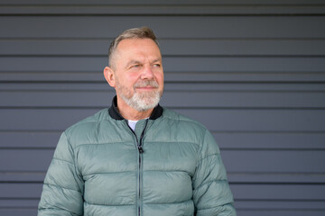 Mature Man Looking to the Side with a Thoughtful Smile