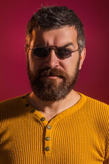 Obraz premium Blind man. Visually impaired. Despite disability. Bearded blind man wearing glasses, studio portrait. Blinded people concept. Disability and blind. Blind mature man, close up face.