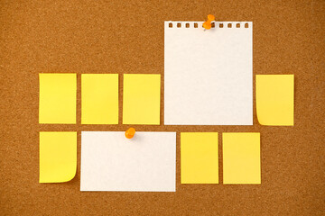 Blank sticky note paper on cork board wall. Noticeboard to organize life and work concept