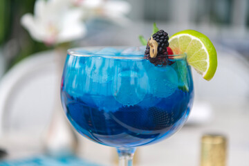 Blue lagoon drink. Aperitif in the bar. Summer refreshing cocktail. Drinking blue lagoon. Glass of...