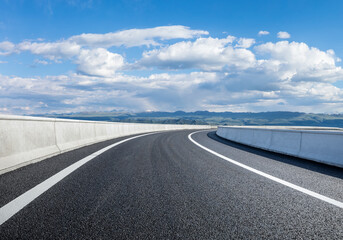 Countryside asphalt road with mountain nature landscape under blue sky. Outdoor road background.