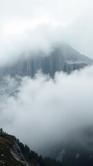 Fog rolls in over a granite peak on a grey morning, granite, morning