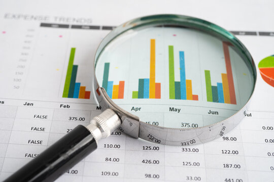 Magnifying glass on charts graphs paper. Financial development, Banking Account, Statistic, Investment Analytic research data economy.