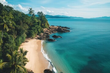 Secluded tropical beach with palm trees, turquoise water, and rocky shoreline.