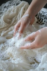 Fototapeta premium Hands wash fabric in soapy water.