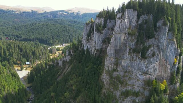 Aerial drone shot through  spectacular  canyon of limestone shale conglomerate rocks  , winter landscape in the Zanoaga Gorge , Bucegi Natural Park , Carpathian Mountains, Romania