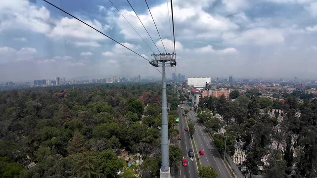 shot of cablebus flying over graveyard in chapultepec mexico city