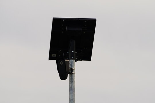 Flock safety police law enforcement license plate reader set up outside to help catch vehicle speeders.