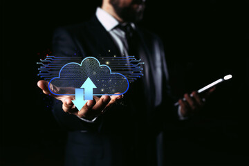 Businessman holding mobile phone which on the top of phone has upload and download cloud space...