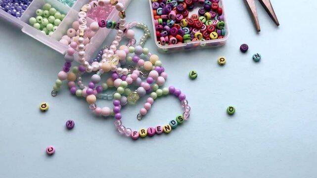 Crafting colorful bracelets with beads and tools on a table