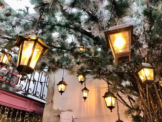 decorative lanterns with light bulbs shine on the terrace