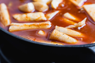 Steaming hot tteokbokki and fish cakes, a popular Korean street food made from rice flour
