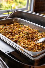 Delicious stir-fried noodles are served in the buffet, offering a flavorful option for guests