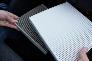 Close-up of an air filter in a car. Concept of the automotive industry. Old and new air filter.