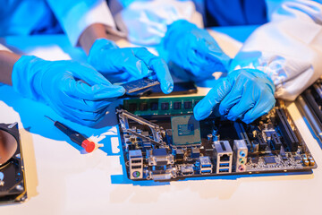 Close-up of a technician wearing gloves soldering electronic components at a desk in an office. The scene highlights precision, technical expertise, and focused work in an electronics lab setting