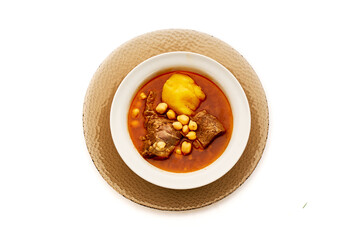 A bowl of food with meat and beans in it