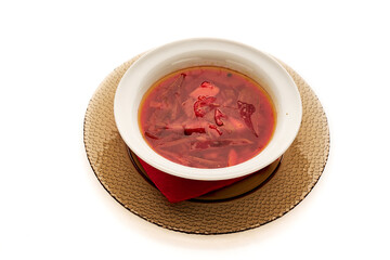 A bowl of soup with a red napkin on top