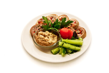 A plate of food with a variety of vegetables and a dip