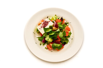 A plate of food with a variety of vegetables and a sauce
