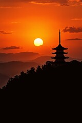 Fototapeta premium Silhouette of a Traditional Pagoda Against a Vibrant Sunset