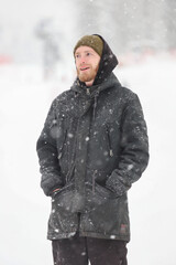 a man walks in a snow blanket, it's snowing heavily, the man is in full growth