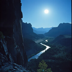 moonlight shining on rugged cliffs in the Rockies, creating dramatic shadows, a river winding far below