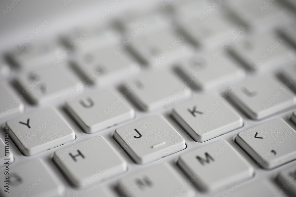 Aufkleber close-up of white keyboard with focused j key - modern technology and computing concept