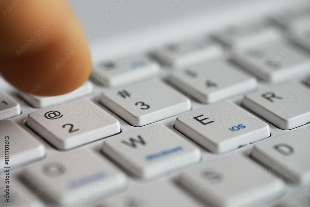 Poster close-up of finger pressing key on white computer keyboard