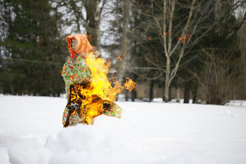 Traditional Burning Effigy in Snowy Winter Forest Scenery during Festive Ritual