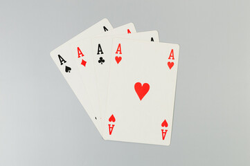 Top view of playing cards on grey background. Four aces cards, board game, poker. Copy space, flat lay.