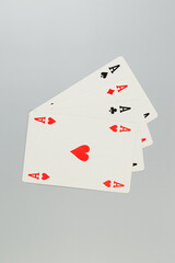 Top view of playing cards on grey background. Four aces cards, board game, poker. Copy space, flat lay.