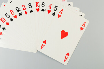 Top view of playing cards on grey background. Board game, poker. Copy space, flat lay.