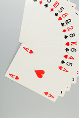 Top view of playing cards on grey background. Board game, poker. Copy space, flat lay.
