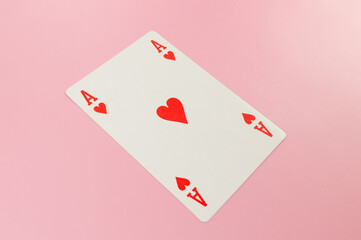 Top view of playing cards on pink background. One ace card, board game, poker. Copy space, flat lay.