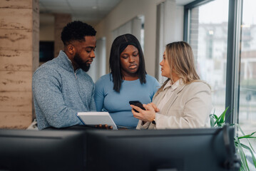 Businesspeople discussing a project using smartphone and notebook in the office