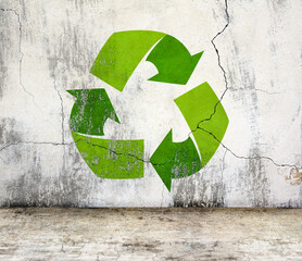 Arrows recycle symbol on old stucco wall and concrete floor. Rugged weathered urban wall backdrop....