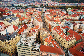Prague architecture, aerial view. Historical buildings with red roofs in European city. Birds eye...