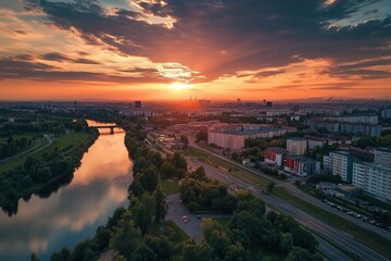 Fototapeta premium Vibrant sunset over city river and buildings.