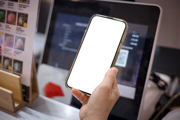 Close-up of woman holding smartphone with blank screen to scan for payment.