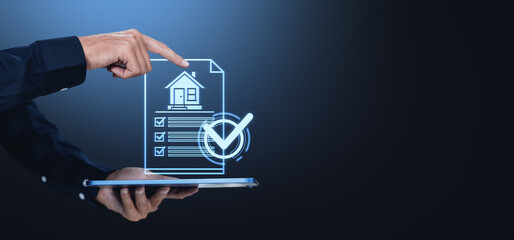 Hand pointing at virtual house document with checklist on digital tablet, blue background.