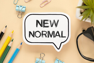 New normal concept. top view of a white card with an inscription, glasses and concierge items. On the yellow table