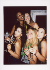 A vintage-style instant camera photo of friends enjoying a lively party, holding drinks and...