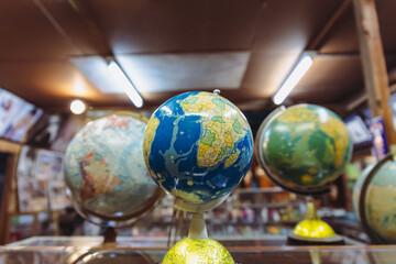 world map with 3 globes in a vintage room