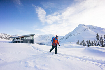 Backcountry skier leaving Kees and Claire Hut, Whistler B.C.